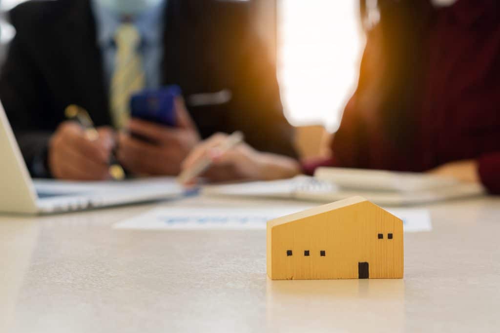 Dealers are recommending homes to new owners after agreeing to a home sales contract. Renting and Buying a House Idea Image of a real estate agent explaining to clients about an ownership agreement.