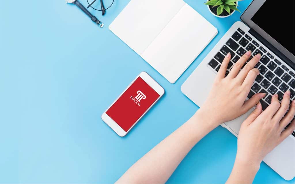 Hands typing at laptop